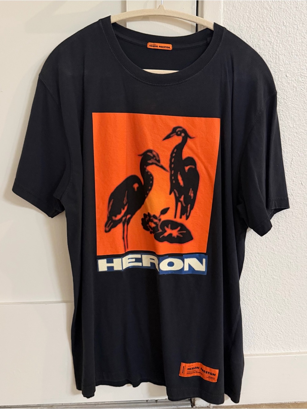 Heron Preston Black Tee with Orange Graphic Panel and Blue Logo